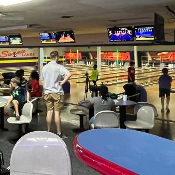 Bowling alley with people bowling